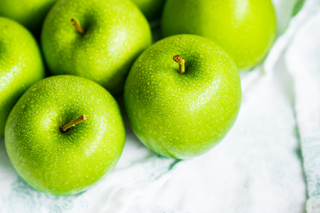 Bright green apples on white napkinの写真素材