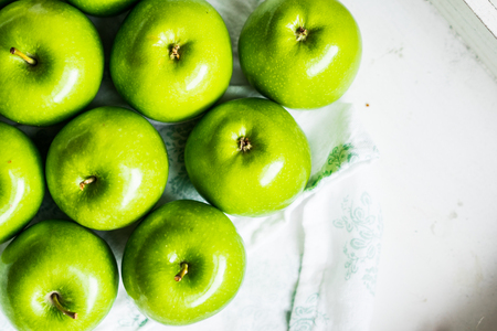 Bright green apples on white napkinの写真素材