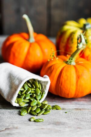 Pumpkin seeds on rustic backgroundの写真素材