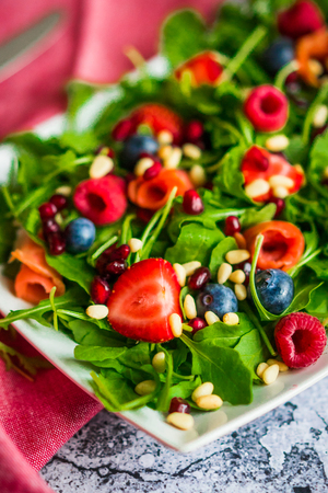 Healthy salad with arugula,spinach,smoked salmon and berriesの写真素材