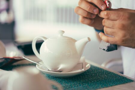 White teapot in the restaurantの写真素材