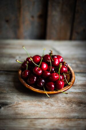 Sweet cherries on rustic wooden backgroundの写真素材