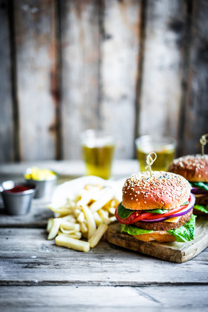 Homemade burgers on rustic wooden backgroundの写真素材