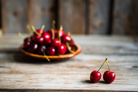 Sweet cherries on rustic wooden backgroundの写真素材