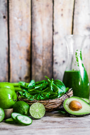 Mix of green fruits and vegetables on rustic wooden backgroundの写真素材
