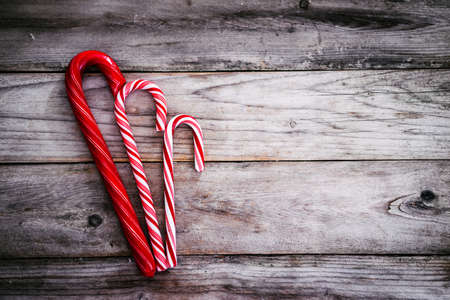 Candy canes on rustic wooden backgroundの写真素材