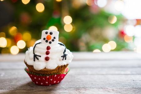 Snowman cupcake on wooden backgroundの写真素材