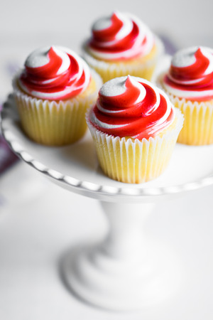 Strawberry and vanilla cupcakes on white backgroundの写真素材