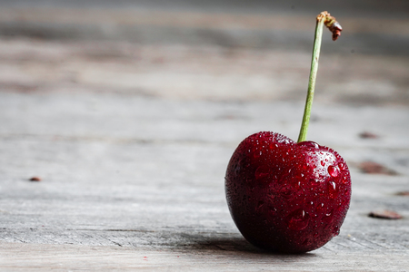 Closeup of a cherry on wooden backgroundの写真素材
