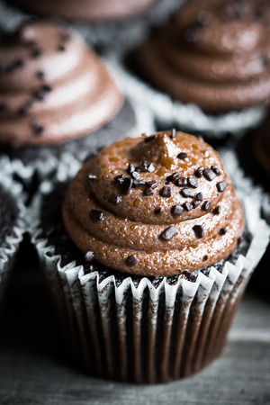 Chocolate cupcakes on rustic wooden backgroundの写真素材