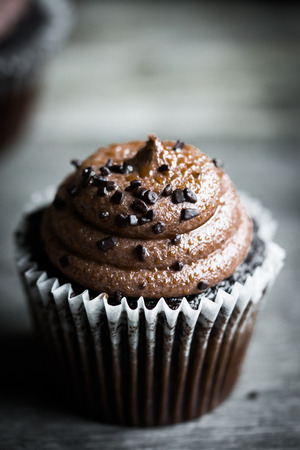 Chocolate cupcakes on rustic wooden backgroundの写真素材