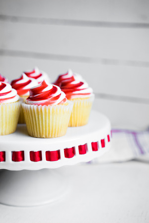 Strawberry and vanilla cupcakes on white backgroundの写真素材