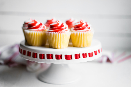 Strawberry and vanilla cupcakes on white backgroundの写真素材