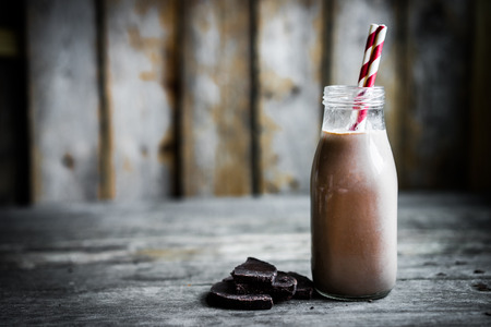 Chocolate milk in a jar on wooden backgroundの写真素材