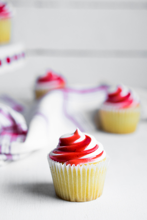 Strawberry and vanilla cupcakes on white backgroundの写真素材