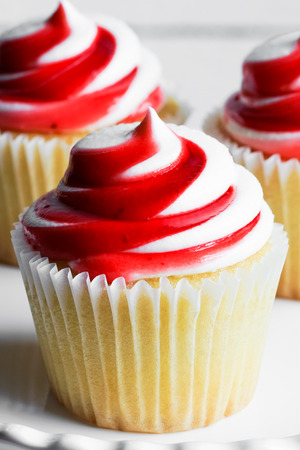 Strawberry and vanilla cupcakes on white backgroundの写真素材