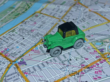 Green toy car on a map of the city, close-upの写真素材