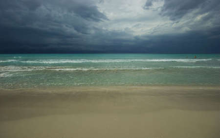 Empty tropical beach. Stormy sky. Background.の写真素材