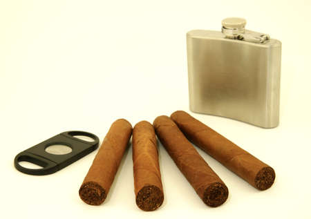 Close up of  4 cigars, cigar cutter and hip flask
の写真素材