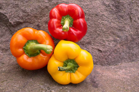 Red, Yellow, and Orange Bell Peppers の写真素材