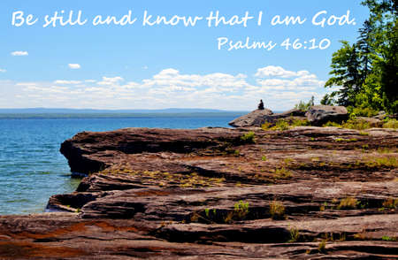 Man on cliff overlooking Lake Superior with quote,  Be still and know that I am God  の写真素材