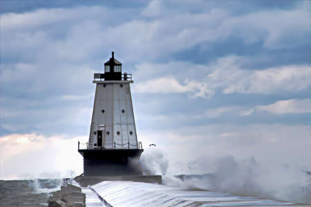 Waves crash onto the Ludington Lightouse pier  Ludington Waterfront Municipal Park  Ludington, Michigan  の写真素材