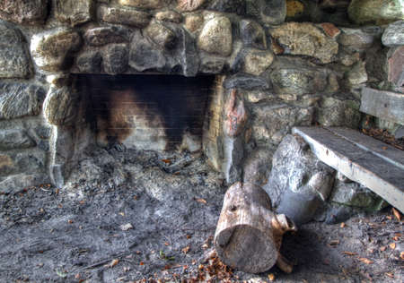 Historic trailside hiking shelter with stone fireplace and bench  Built by the CCC in the Great Depression Era and still in use today  Ludington State Park  Ludington, Michigan  の写真素材