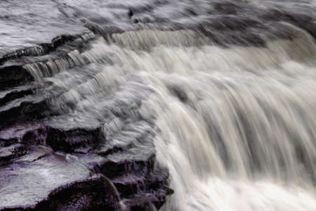   Spring flooding rushes over a rock precipice  Time to clean the storm drains and gutters, and...