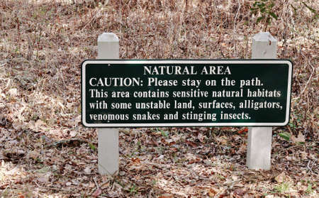 Enjoying the great outdoors, sign warning of the dangers of straying off the beaten path の写真素材