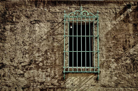 What Lies Within  Stone wall with bars and bare light bulb in a darkened room  Huntington Beach State Park  Myrtle Beach, South Carolina の写真素材