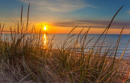 Sunrise over the beautiful watery horizon signifies the dawn of a new day  の写真素材