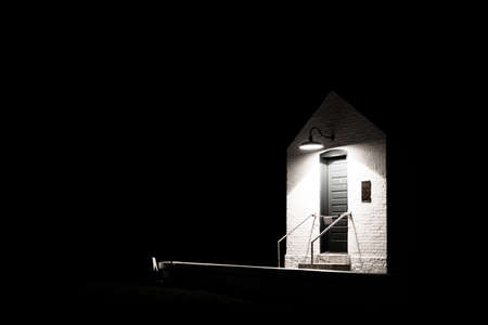 Entrance to the Fort Gratiot Lighthouse illuminated by a single light and surrounded by darkness  Lighthouse Park  Port Huron, Michigan   の写真素材