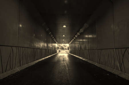 Light At The End Of The Tunnel  Pedestrian tunnel illuminated by sunlight at the exit  の写真素材
