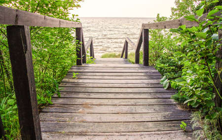 Wooden walkway and steps leading to the lake  の写真素材