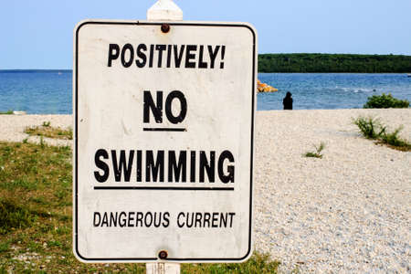 Warning sign to swimmers of dangerous currents  の写真素材
