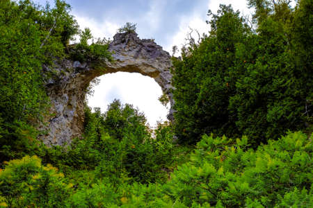 Arch Rock is a seastack carved from centuries of wind and water erosion from the Great Lakes  It is the most famous natural landmark on Mackinaw Island, Michigan  の写真素材