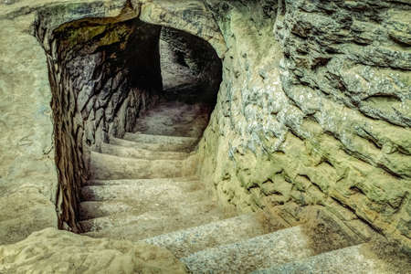 Ancient winding stone stairway leads into the unknown.の写真素材