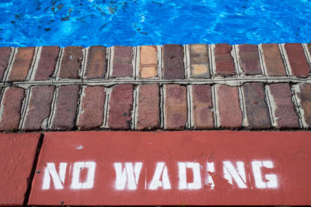 Forbidden Water. Sign warning the passerby to stay out of the water.の写真素材