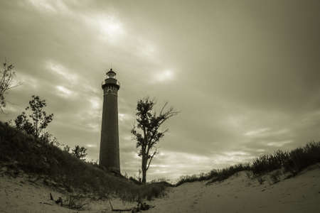 Guiding Light. The historical Little Sable Light on the shores of Lake Michigan under stormy skies. Silver Lake State Park. Mears, Michigan.の写真素材