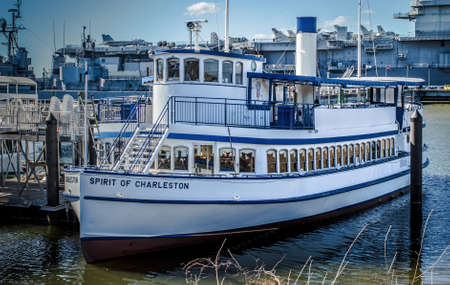 Charleston, SC. March 1, 2015. The Spirit Of Charleston docked at Patriots Point with the USS Yorktown aircraft carrier in the background.のeditorial素材