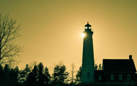Lighthouse Silhouette. The Tawas Point Lighthouse has stood on the shores of Lake Huron for over a century. Tawas State Park. Tawas City, Michigan.の写真素材