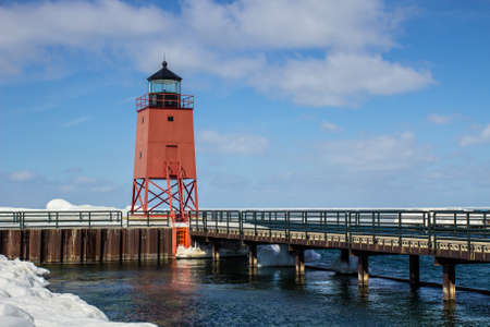 Winter Great Lakes Lighthouse. The Charlevoix Lighthouse on the shores of Lake Michigan surrounded by ice and snow.の写真素材