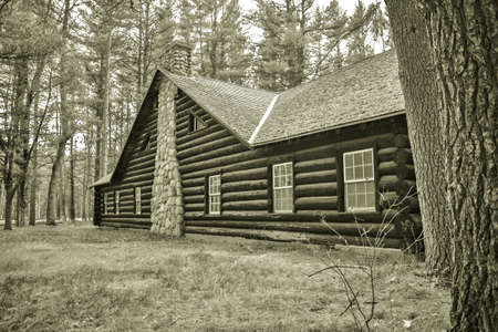 Historical Log Cabin. Exterior wall and chimney of historical log cabin built by the CCC in the 1930's. Hartwick Pines State Park. Grayling, Michigan. This is a public building located on public lands and is not a private residence.のeditorial素材