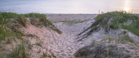 Trail To The Beach. Beach path winds through the sand dunes to sandy beach on the shores of Lake Michigan.の写真素材