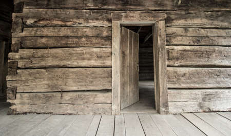 Historical Log Cabin With Open Front Door. Front porch of Appalachian log cabin with opened front door.  This is a historical display in the Great Smoky Mountains National Park and is not a privately owned residence.の写真素材