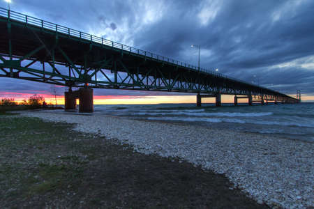 Mackinaw Bridge In Michigan At Sunset. The Mackinac Bridge is one of the longest suspension bridges in the world. It connects Michigan's Upper and Lower Peninsula. It is also part of the North Country Trail.の写真素材