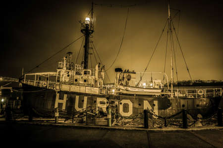 Historical Great Lakes Lightship. The historic landmark Great Lakes light ship Huron with illuminated beacon in horizontal orientation.の写真素材
