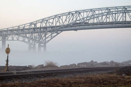Foggy Urban Background. The Blue Water Bridge International border crossing during heavy fog with...