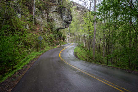Driving In The Mountains. Narrow and winding Appalachian Mountain road with slippery conditions after a rain storm in the scenic Red River Gorge of Kentucky.の写真素材