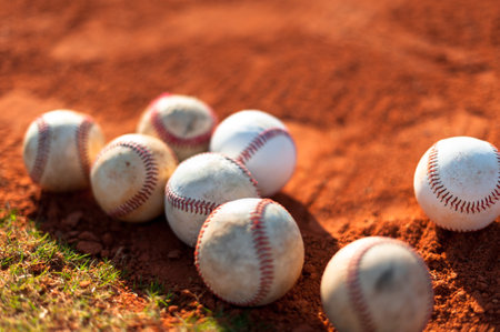Several old baseballs on infield dirt of baseball field diamondの写真素材